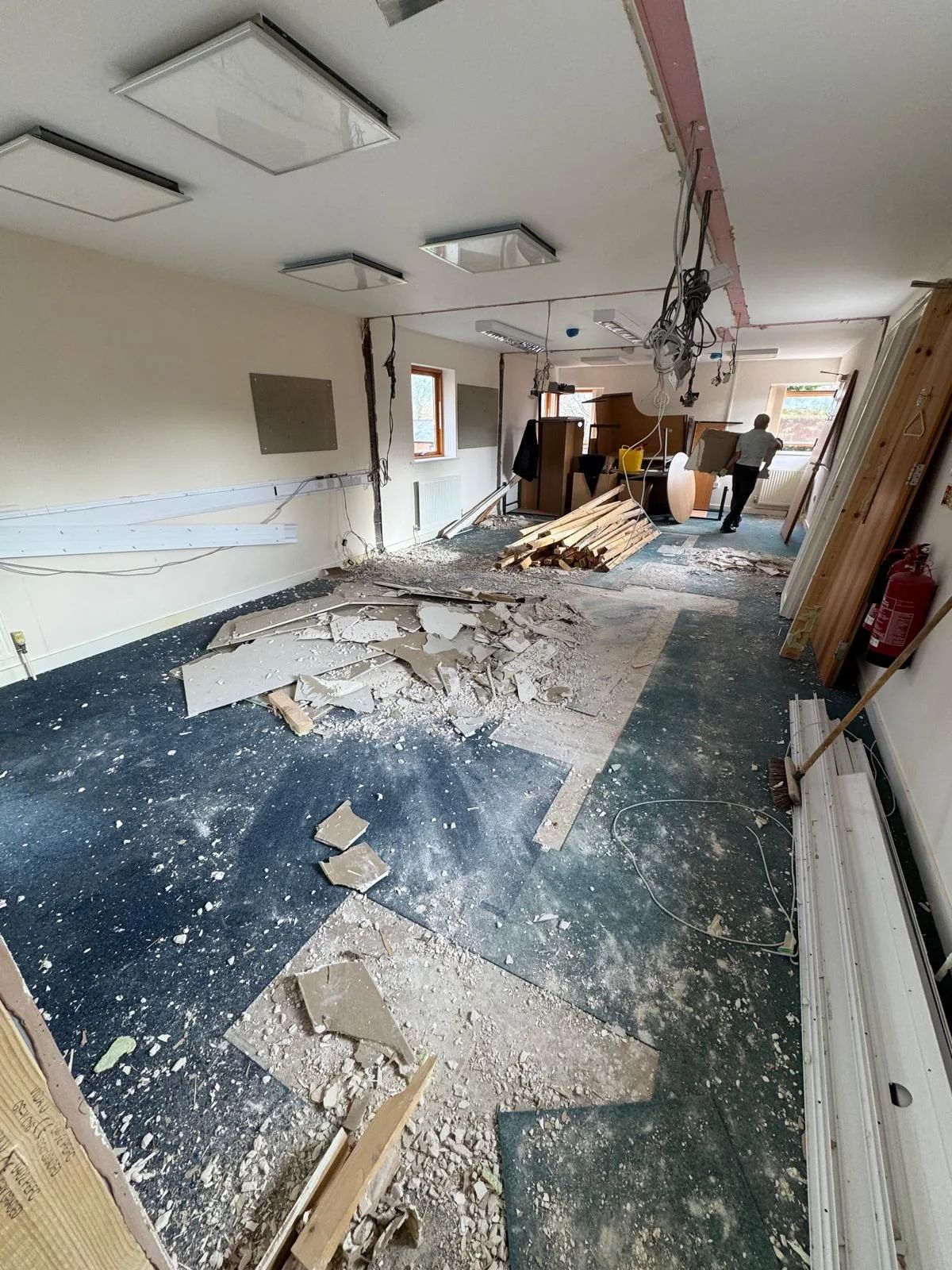 A room stripped back to the walls, rubble across the floor