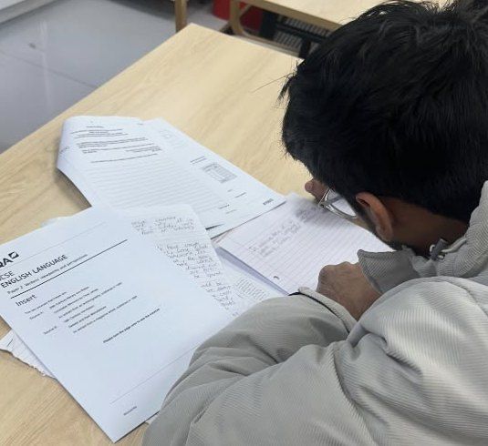 A student working on a GCSE English Language paper